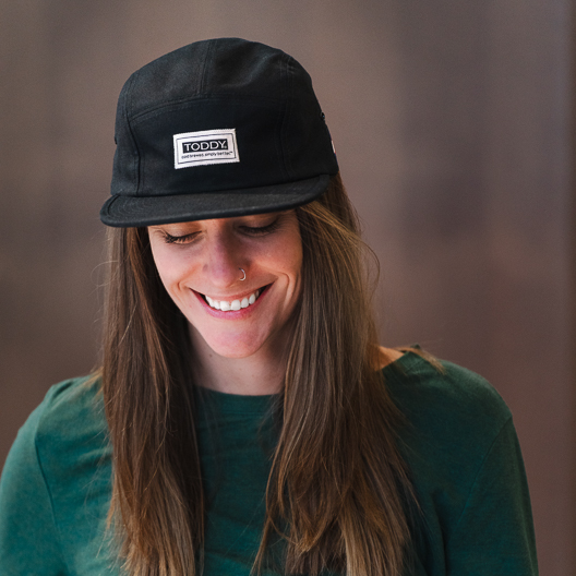 Woman wearing Toddy branded 5 panel hat