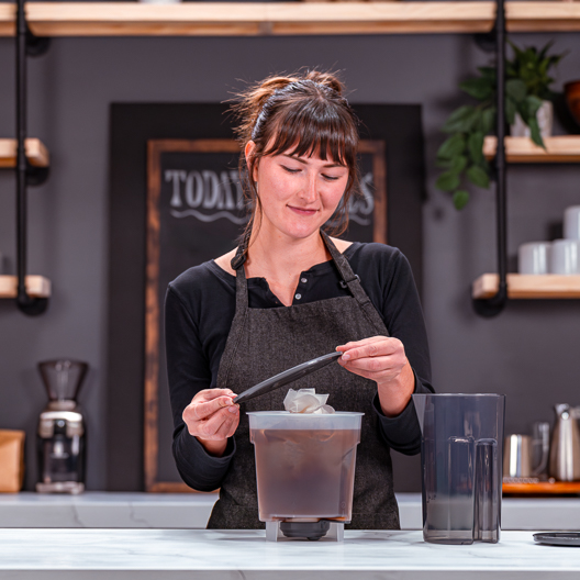 Toddy Essential Brewer-Food Service Edition Barista Placing Lid on Brewer