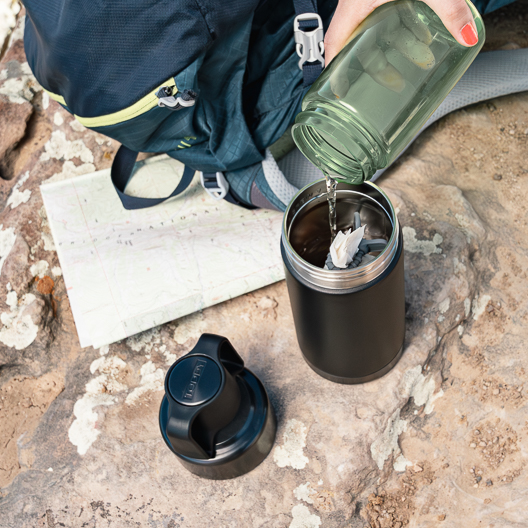 Adding water to the Gunmetal and Black Go Brewer while hiking