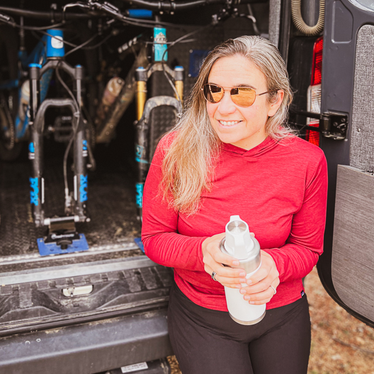 Woman enjoying Cold Brew from Toddy Go Brewer after a mountain bike ride