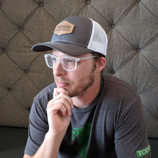 Toddy trucker hat with polygon logo on person