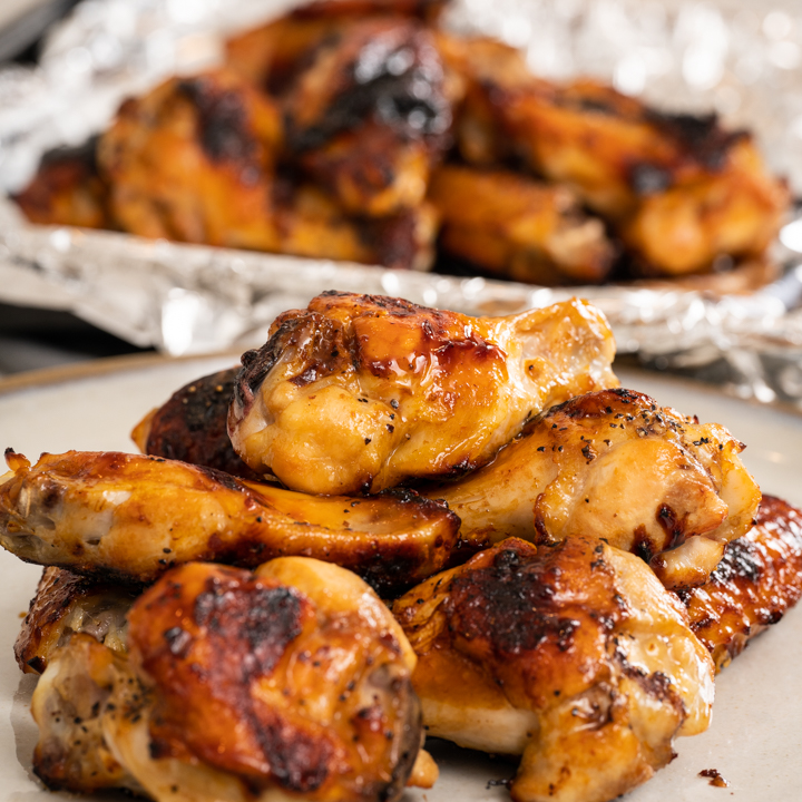 Apricot tea chicken wings cooked and plated with pan in the background