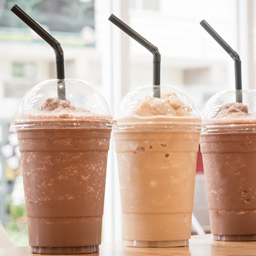 Toddy frappe lineup with chocolate and vanilla frappes in plastic cups with straws